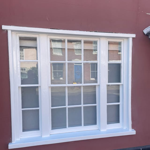 After: the same sash window with renewed white finish