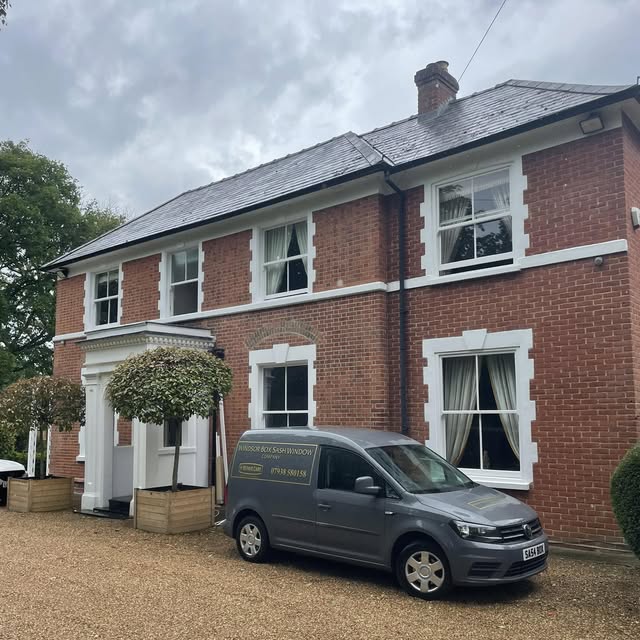 Company van outside a red brick property with traditional sash windows