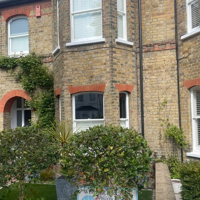 Traditional sash windows across a brick bay facade